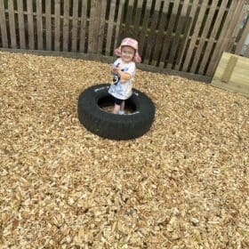 Child playing in Tiny Tree Leeds outdoor area.